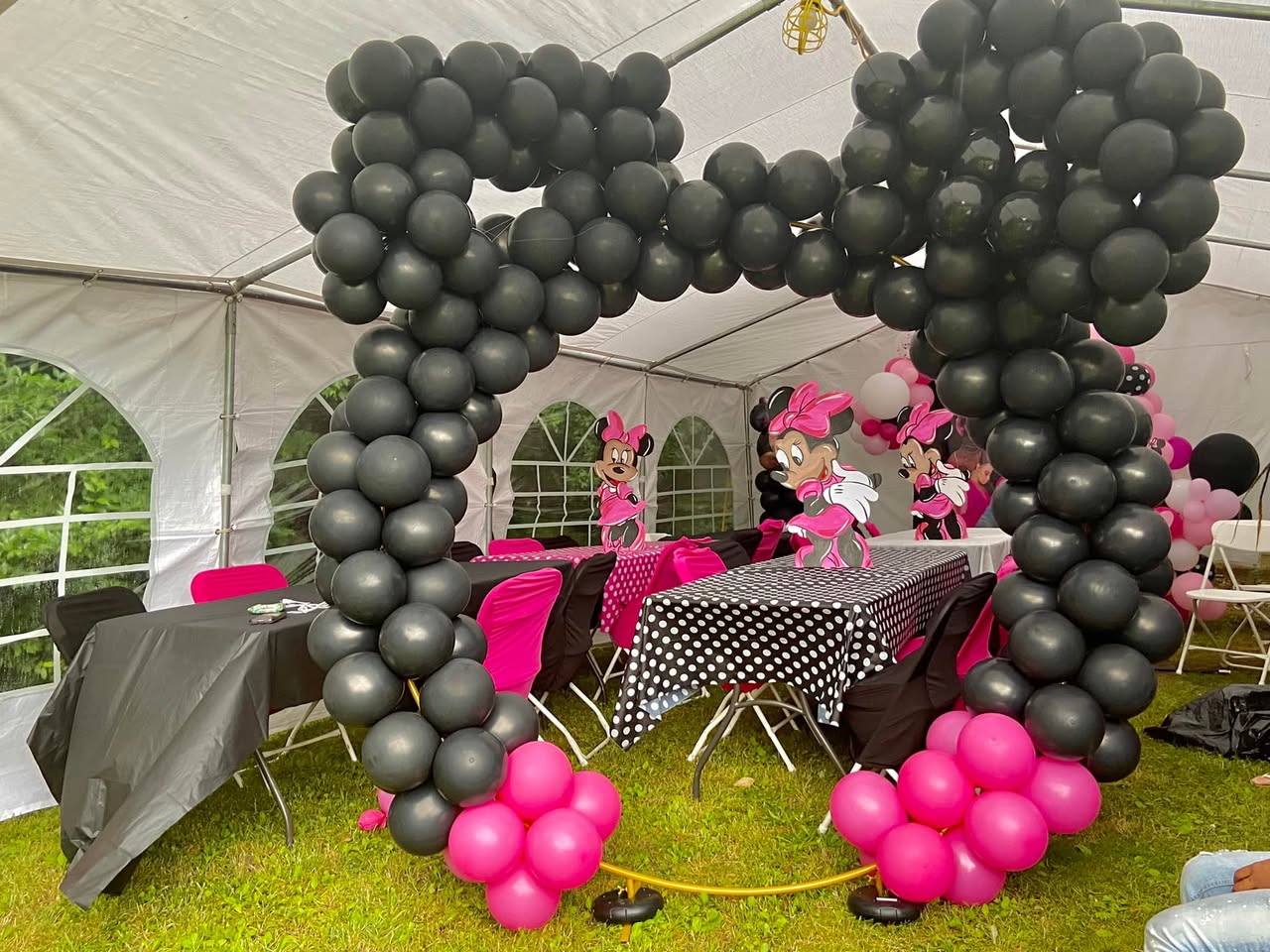 Minnie Mouse Party - Black and pink balloon arch under outdoor tent by Buchannon Events